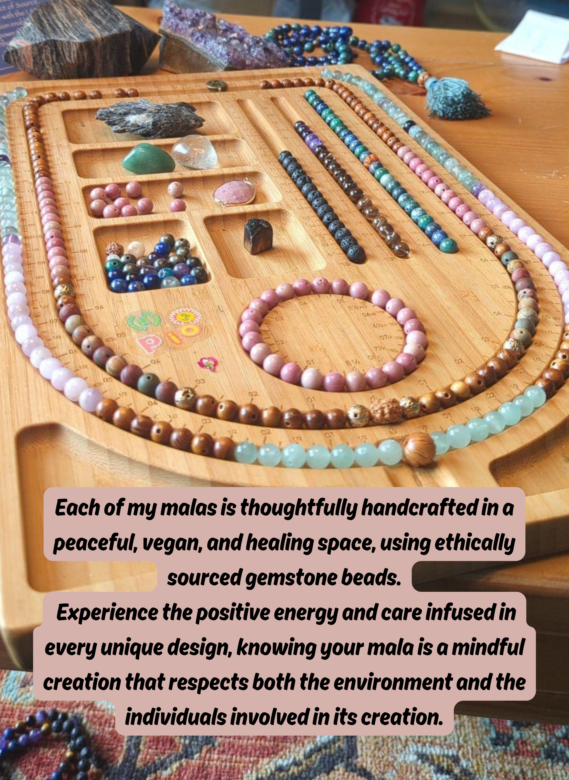Wooden mala with colorful beads on a wooden surface, surrounded by stones and gemstones.